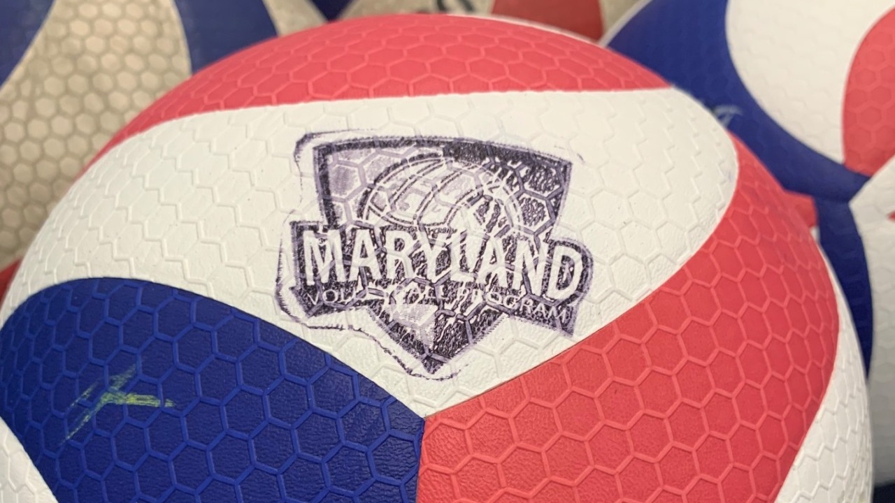 Close-up of MVP (Maryland Volleyball Program) branded Mikasa volleyballs — red, white, and blue with the MARYLAND VOLLEYBALL PROGRAM logo