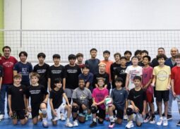 Mixed-age MVP Boys team photo with three coaches at AAU Nationals, showing players of all ages together